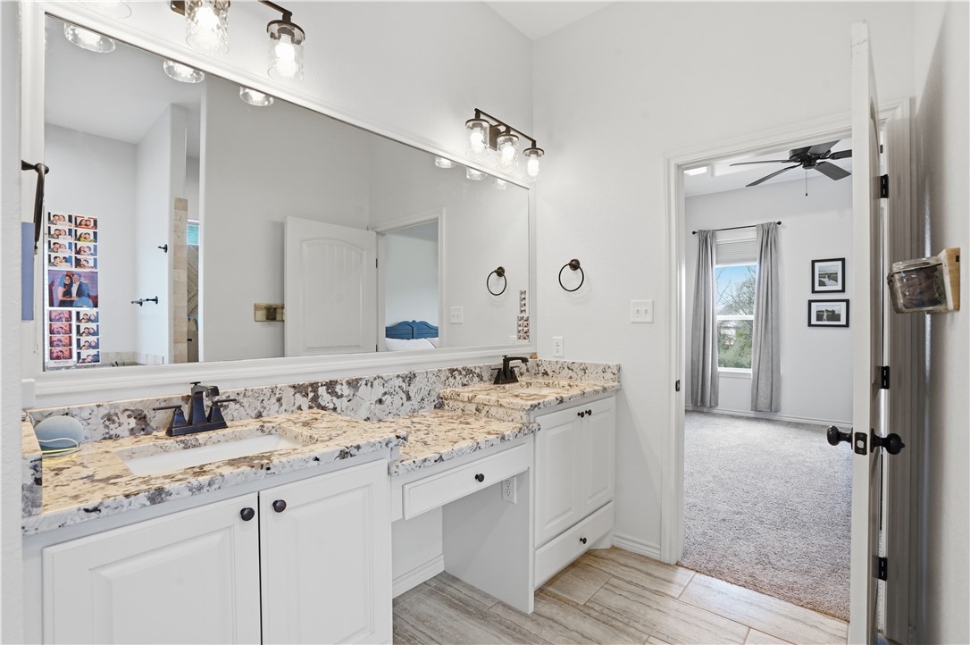 3516 Foxcroft Path Bryan, TX 77808 - Photo 20 of 38 a bathroom with a sink vanity granite and a mirror