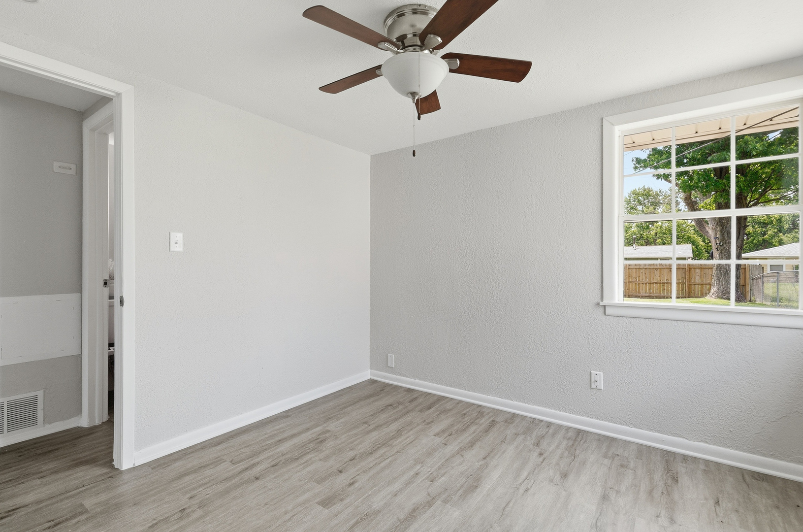 2306 9th Street Silvis, IL 61282 - Photo 24 of 32 an empty room with wooden floor and windows
