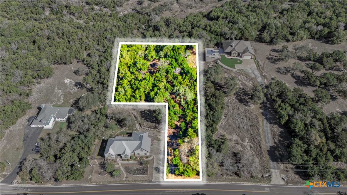 1025 Flaman Road Canyon Lake, TX 78133 - Photo 22 of 31 a view of a yard with potted plants