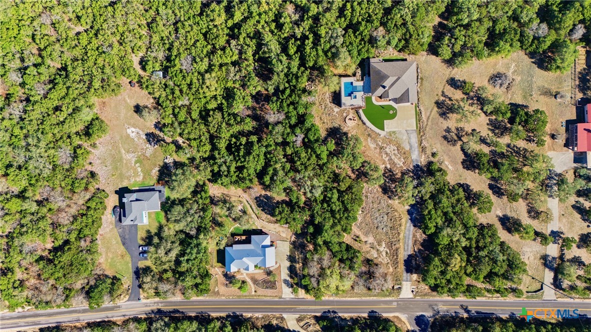1025 Flaman Road Canyon Lake, TX 78133 - Photo 27 of 31 an aerial view of a house with a yard and lake view