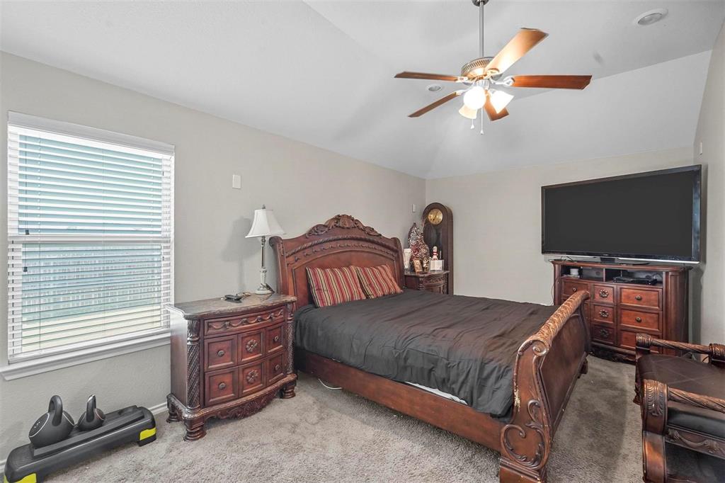 1948 Day Break Drive Lancaster, TX 75146 - Photo 20 of 25 a bedroom with a bed and a flat screen tv