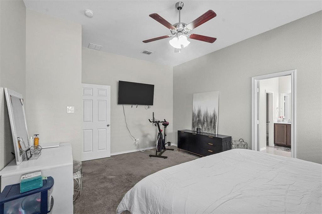 1948 Day Break Drive Lancaster, TX 75146 - Photo 21 of 25 a bedroom with a bed and a flat tv screen on wall