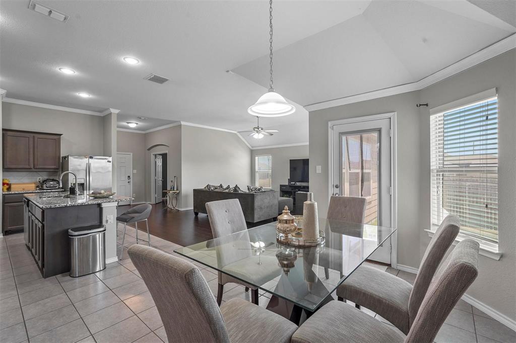 1948 Day Break Drive Lancaster, TX 75146 - Photo 8 of 25 a view of a dining room with furniture a kitchen and chandelier