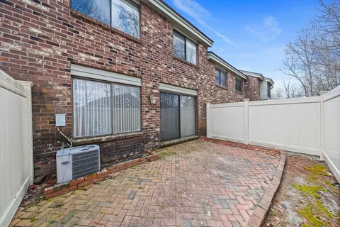 a view of a house with a wooden fence