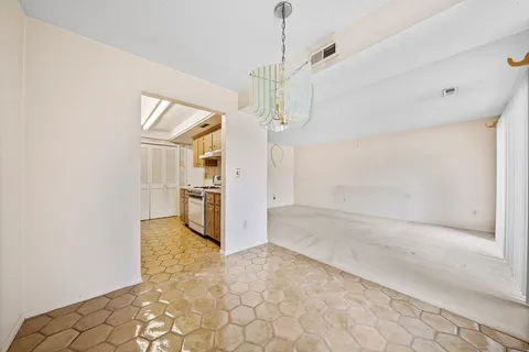 a view of a kitchen with a sink and a refrigerator