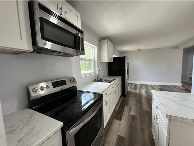 a kitchen with a stove and a microwave