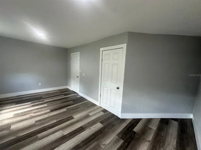 a view of an empty room and wooden floor