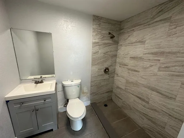 a bathroom with a toilet sink and shower