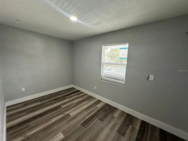 a view of a room with wooden floor and staircase