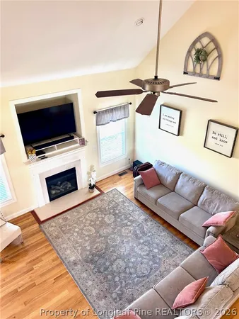 a living room with furniture wooden floor and a table