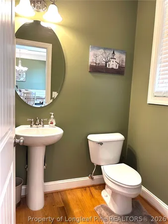 a view of a dining room with furniture wooden floor and chandelier