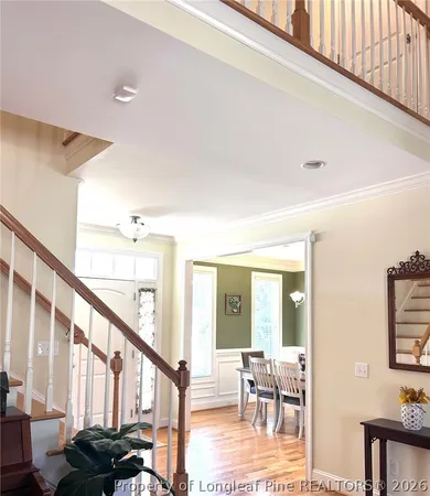 a view of a dining room with furniture wooden floor and a chandelier