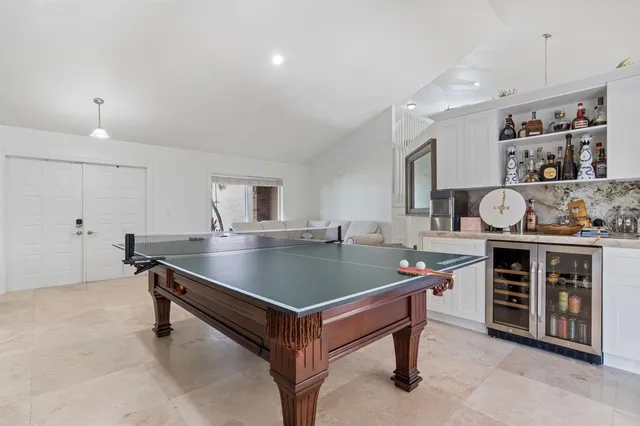 a room with table chairs and stove