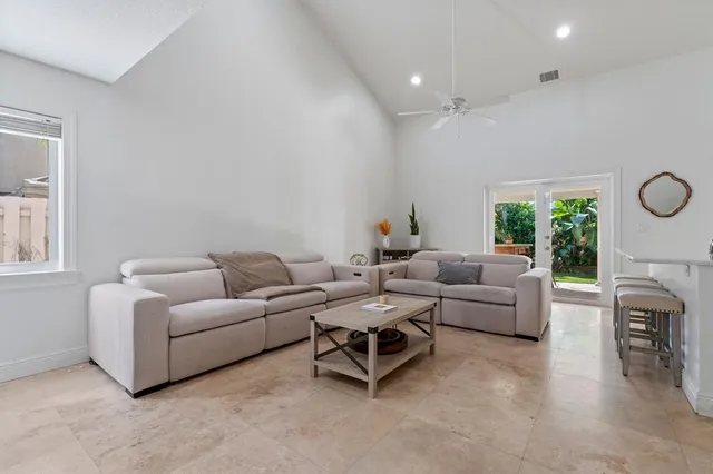 a living room with furniture a fireplace and a large window
