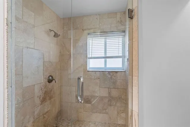 a bathroom with a window and a shower