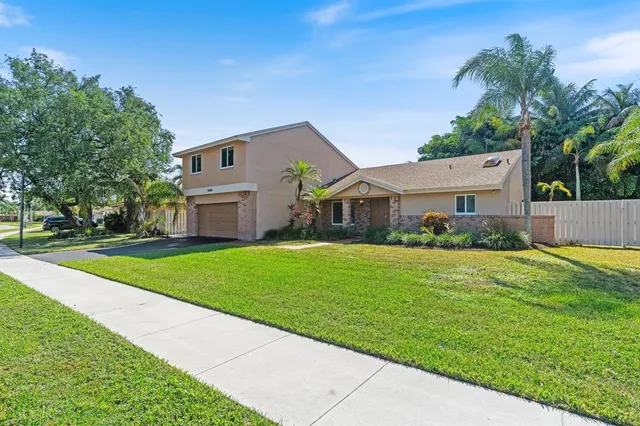 a front view of house with yard and green space