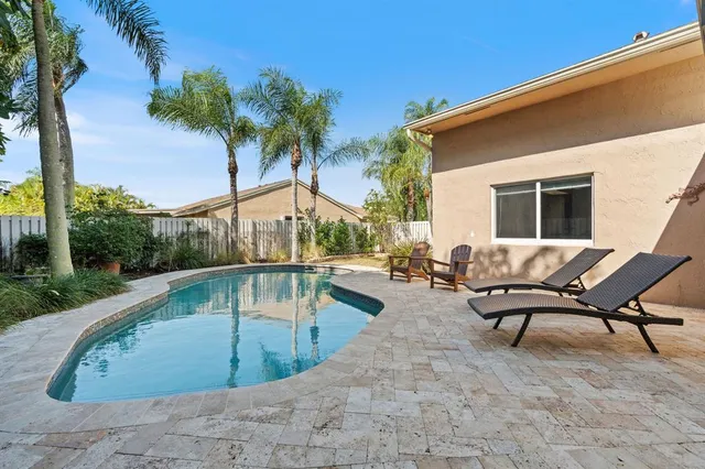 a view of a swimming pool with lounge chair
