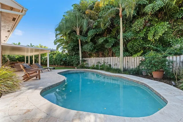 a view of a swimming pool with sitting area