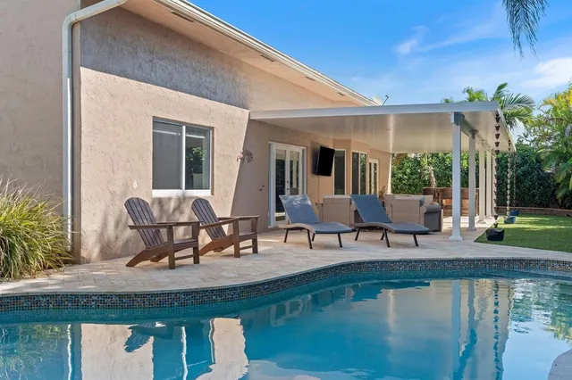 a view of a swimming pool with chairs