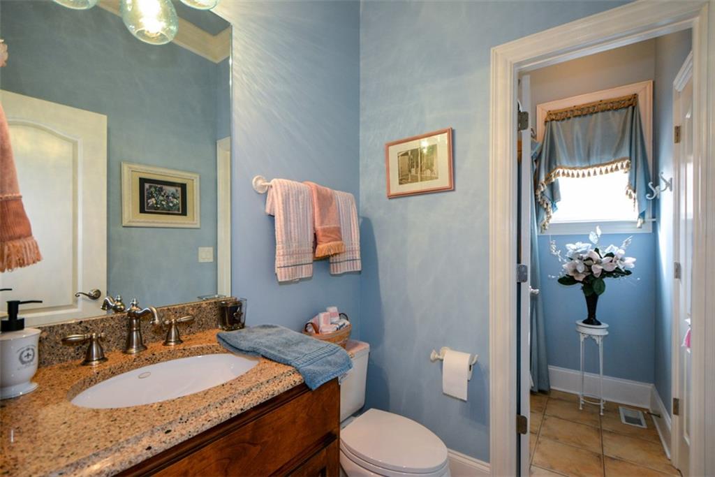 3435 Hidden Shoals Road Northeast Buford, GA 30519 - Photo 21 of 108 a bathroom with a granite countertop sink mirror vanity and toilet