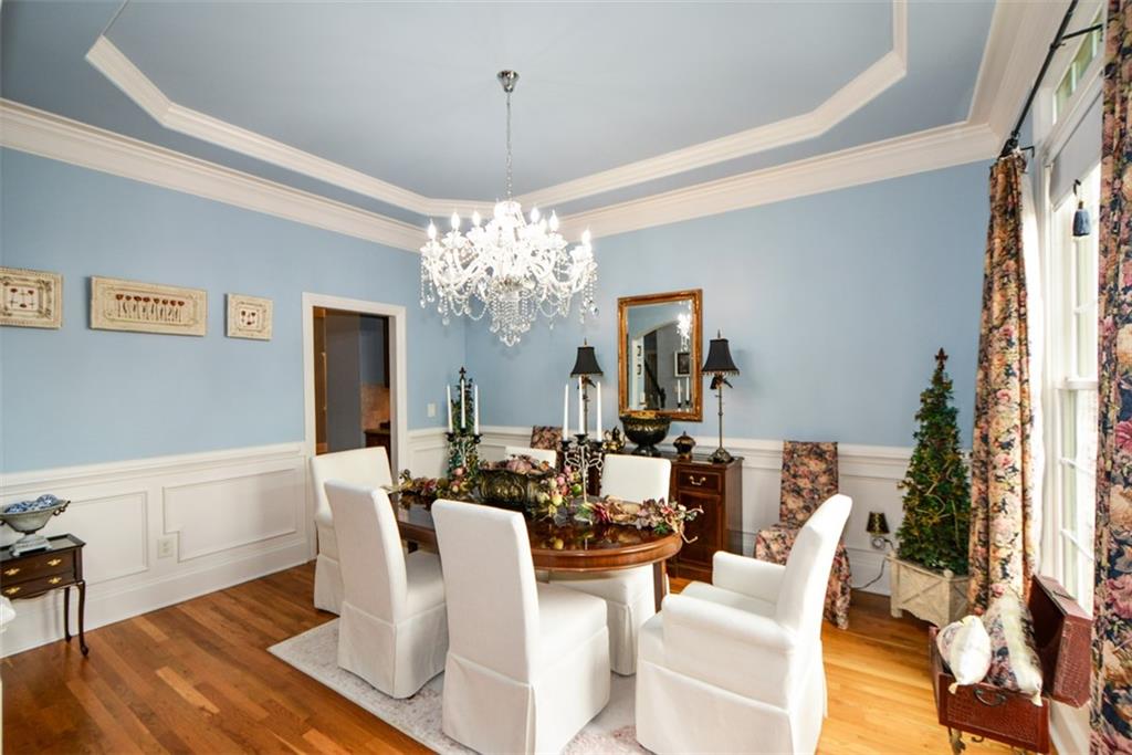 3435 Hidden Shoals Road Northeast Buford, GA 30519 - Photo 27 of 108 a view of a dining room with furniture a chandelier and wooden floor