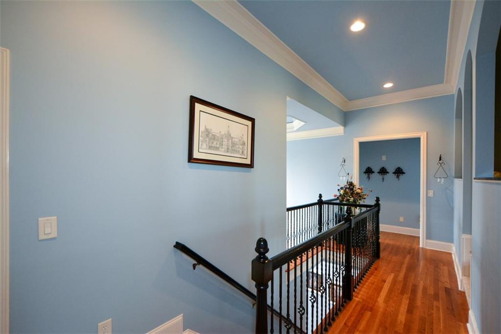 3435 Hidden Shoals Road Northeast Buford, GA 30519 - Photo 44 of 108 a view of a hallway with wooden floor and staircase
