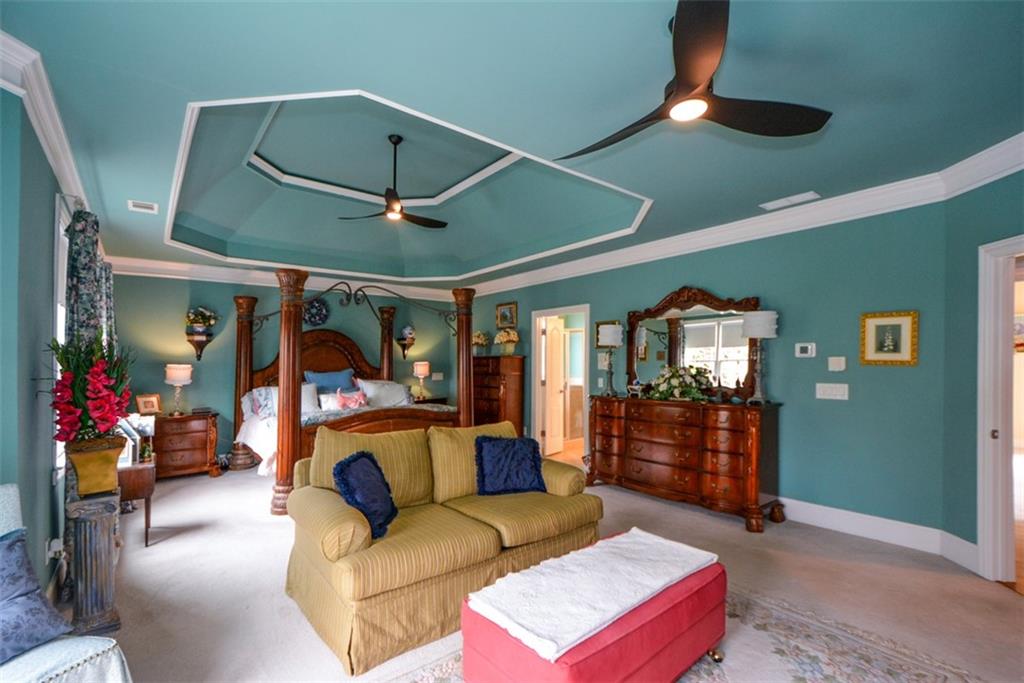 3435 Hidden Shoals Road Northeast Buford, GA 30519 - Photo 50 of 108 a living room with furniture a ceiling fan and a window