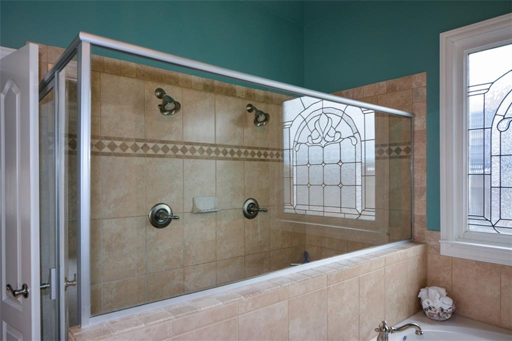 3435 Hidden Shoals Road Northeast Buford, GA 30519 - Photo 57 of 108 a bathroom with a shower and a tub