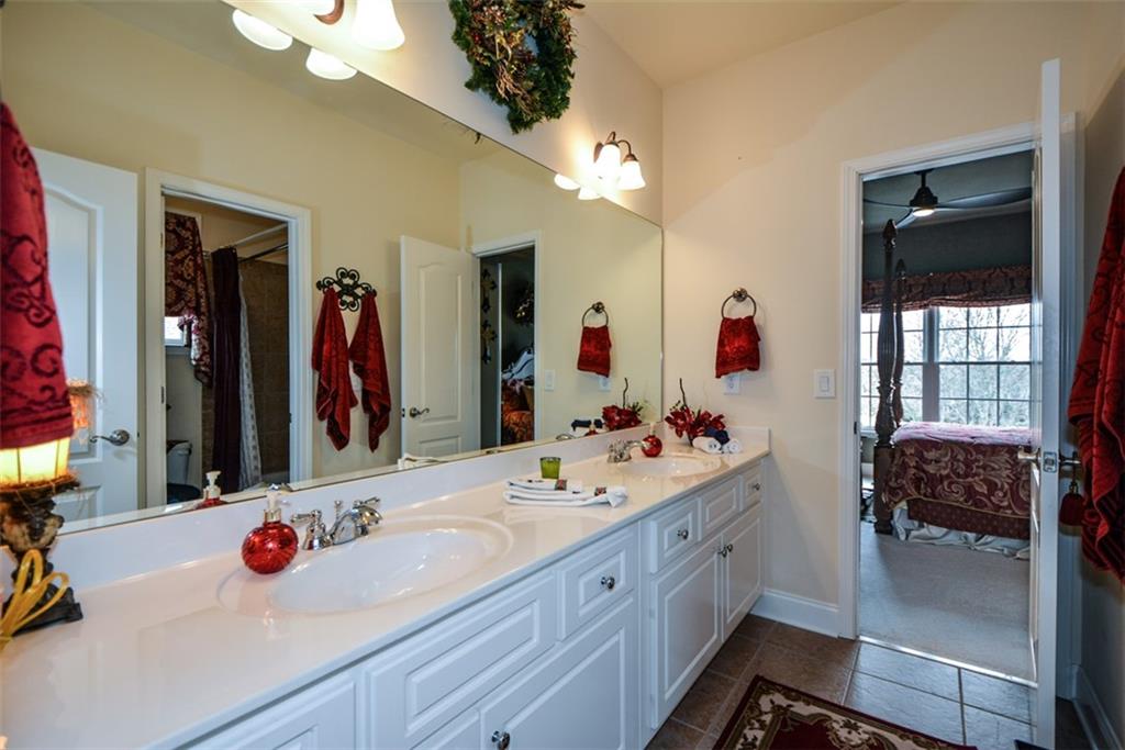 3435 Hidden Shoals Road Northeast Buford, GA 30519 - Photo 64 of 108 a bathroom with a sink vanity tub and a mirror