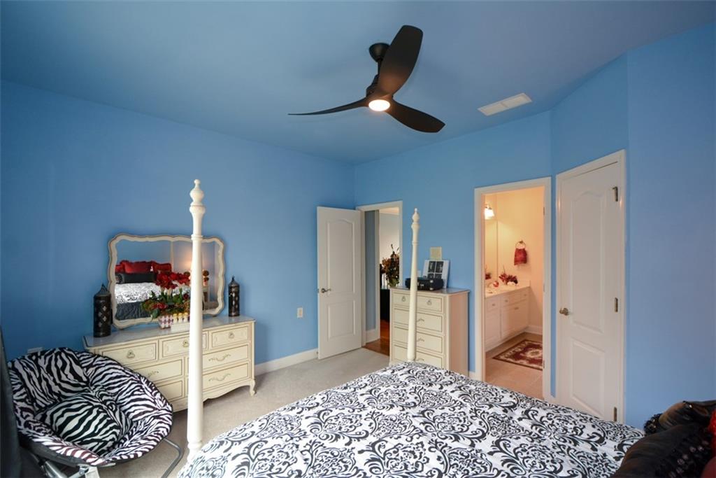 3435 Hidden Shoals Road Northeast Buford, GA 30519 - Photo 68 of 108 a bedroom with a bed and a walk in closet