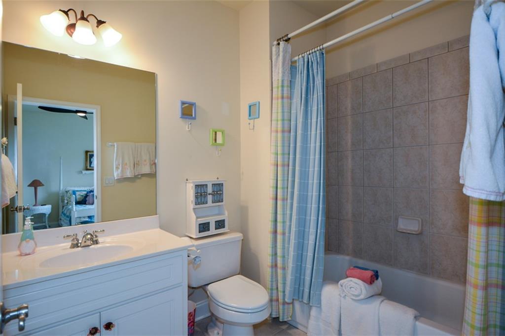 3435 Hidden Shoals Road Northeast Buford, GA 30519 - Photo 69 of 108 a bathroom with a sink a toilet a mirror and shower