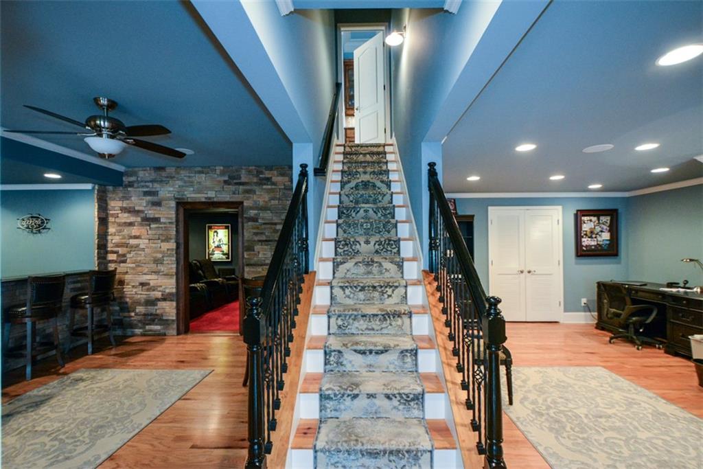 3435 Hidden Shoals Road Northeast Buford, GA 30519 - Photo 71 of 108 a view of a hallway with a couch and chandelier