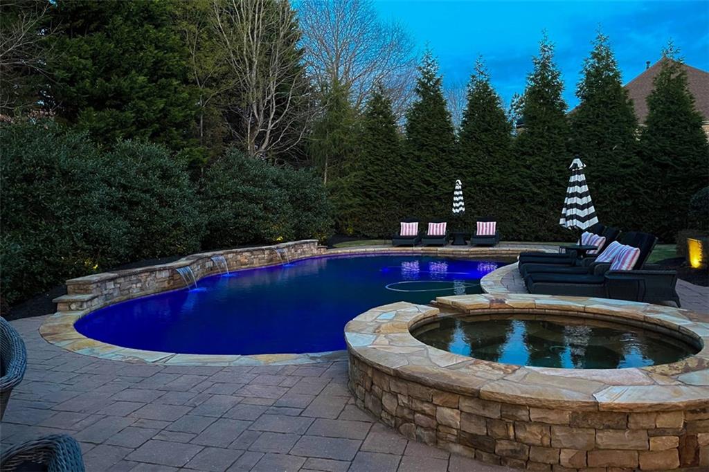 3435 Hidden Shoals Road Northeast Buford, GA 30519 - Photo 94 of 108 a view of outdoor space with swimming pool and trees in the background
