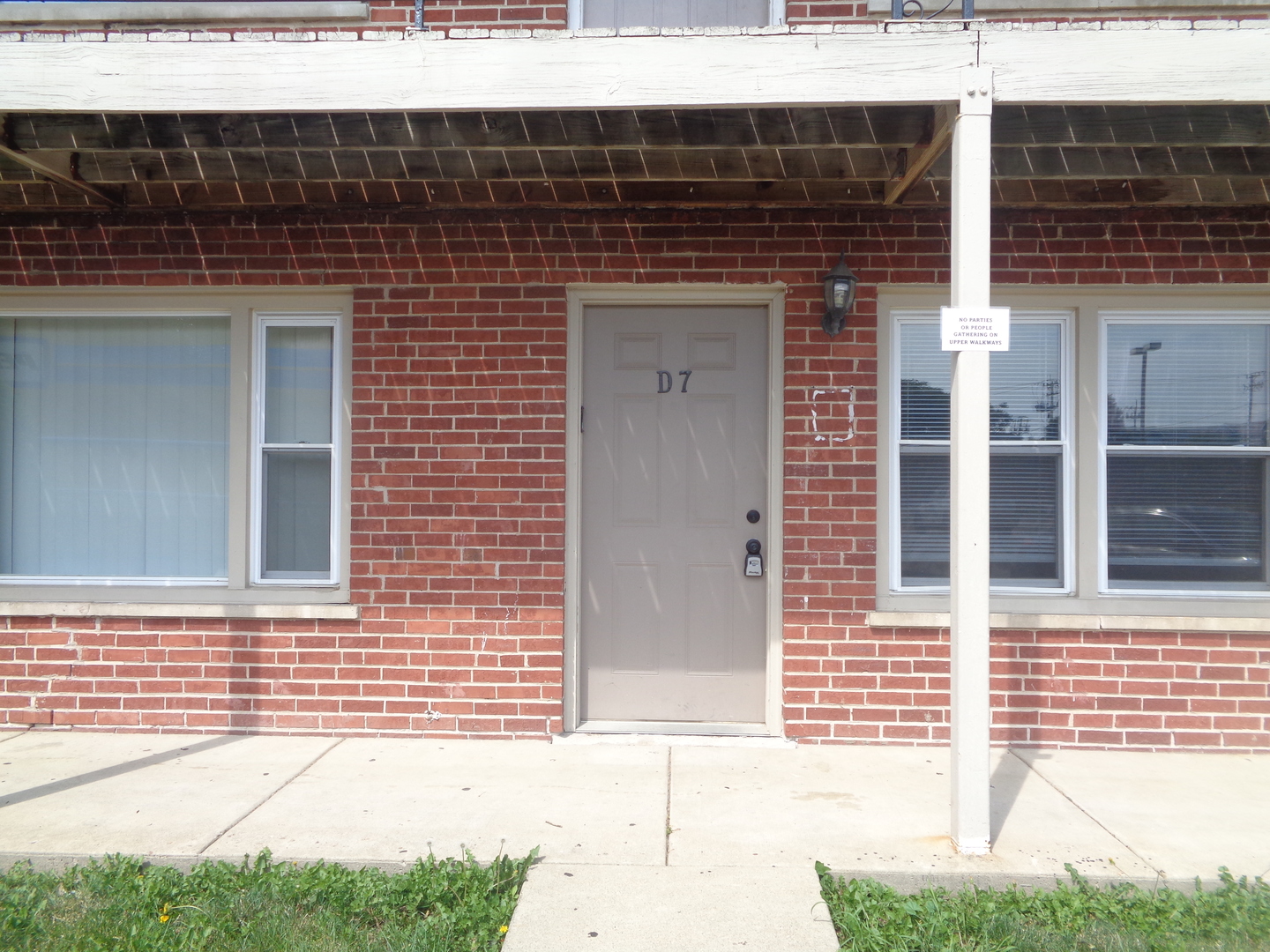 1340 North Main Street, Unit D7 Wheaton, IL 60187 - Photo 1 of 7 a front view of a building with a street