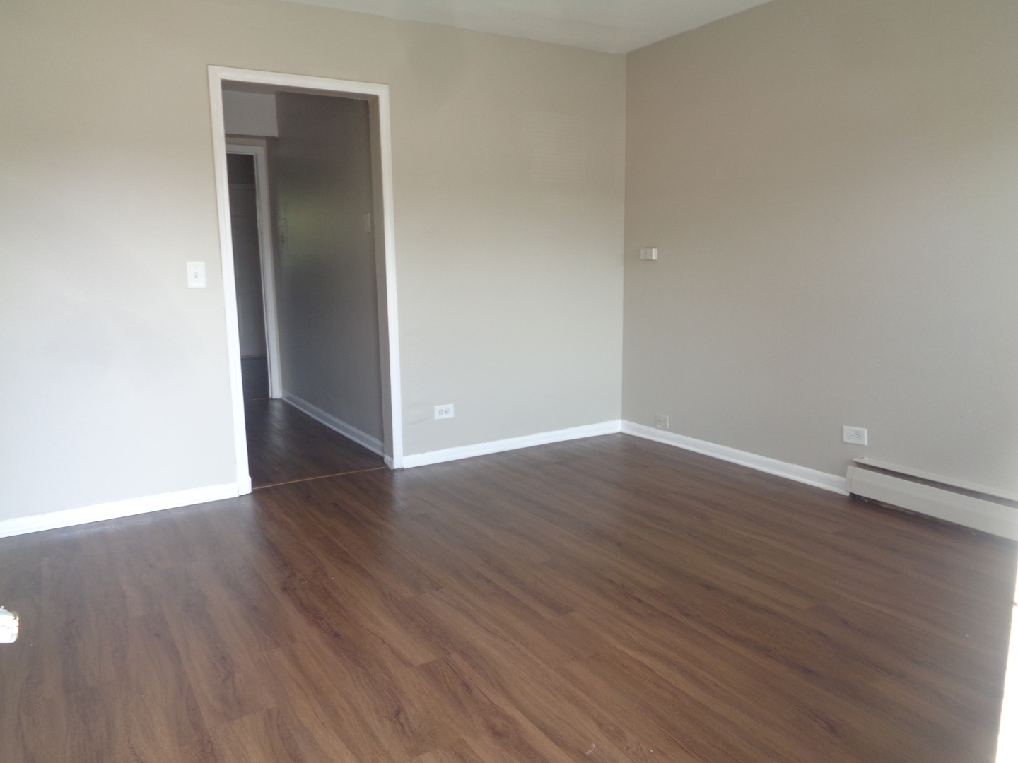 1340 North Main Street, Unit D7 Wheaton, IL 60187 - Photo 2 of 7 a view of an empty room with wooden floor & closet