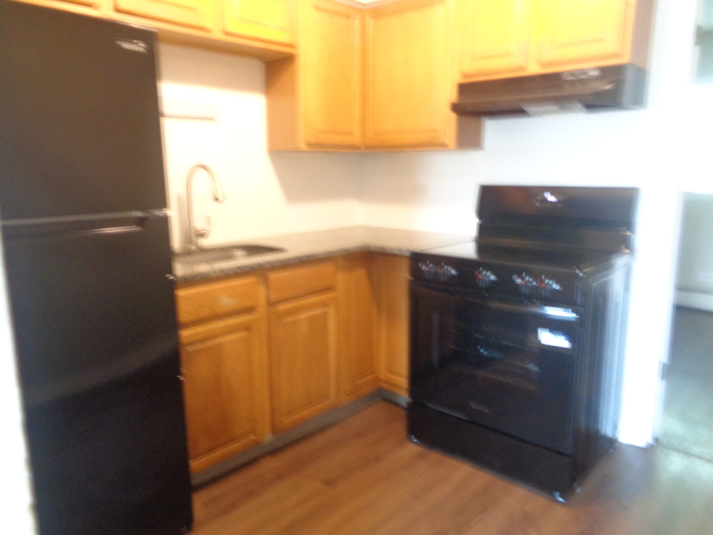 1340 North Main Street, Unit D7 Wheaton, IL 60187 - Photo 4 of 7 a kitchen with a sink and a refrigerator