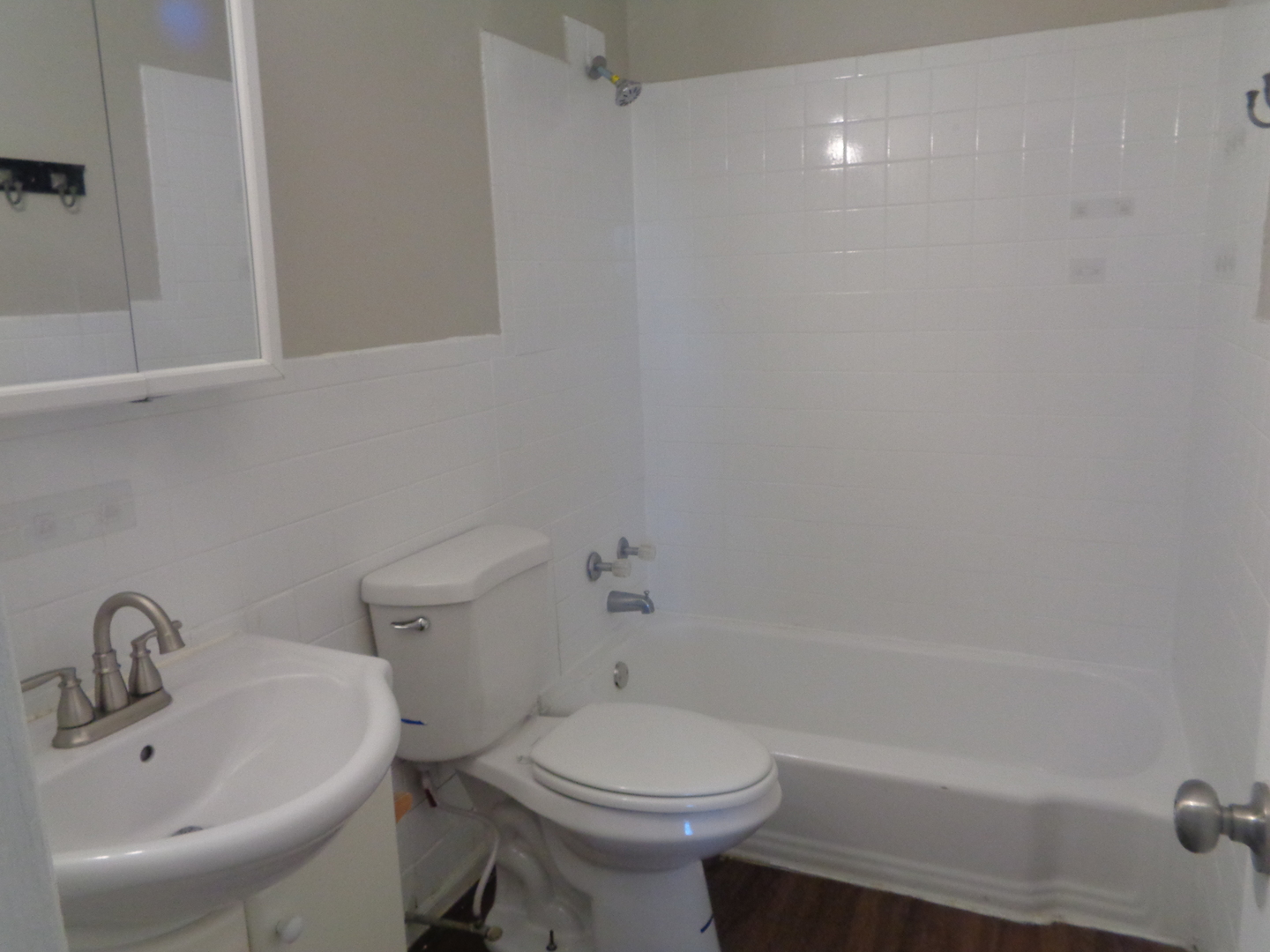 1340 North Main Street, Unit D7 Wheaton, IL 60187 - Photo 6 of 7 a bathroom with a sink a toilet and shower