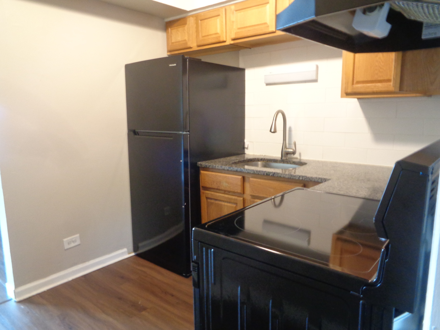 1340 North Main Street, Unit D7 Wheaton, IL 60187 - Photo 7 of 7 a kitchen with a refrigerator and a sink