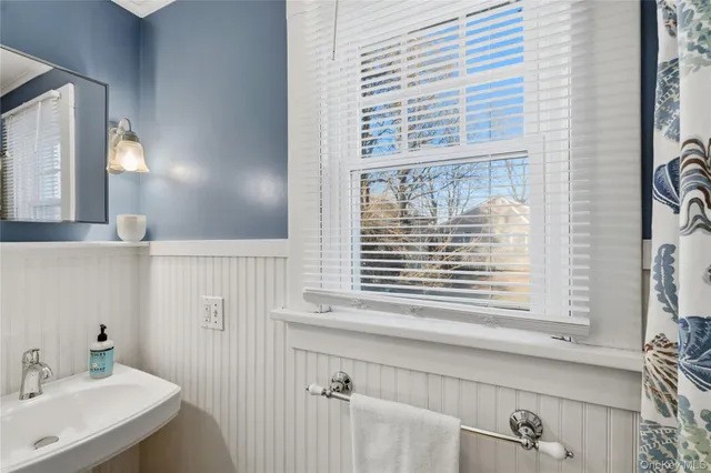 a bedroom with a bed and a mirror on the dresser