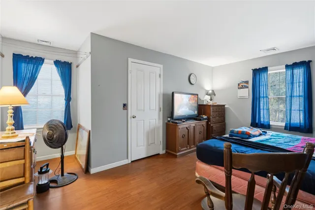a bathroom with a granite countertop sink a mirror and a shower