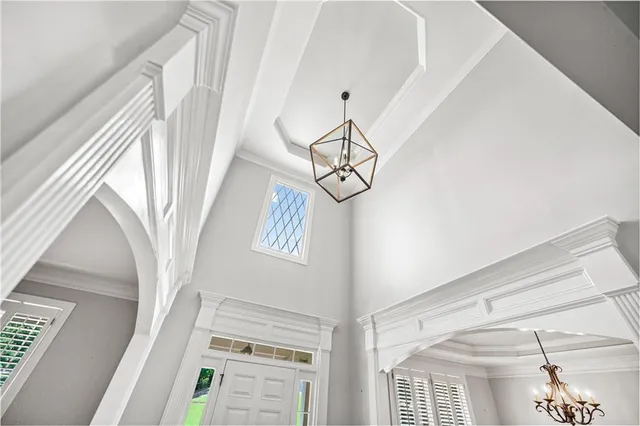 a view of an empty room with wooden floor fireplace and a window