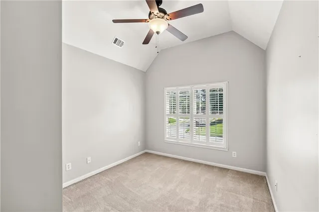 a view of a livingroom with a fireplace a chandelier fan and a fireplace