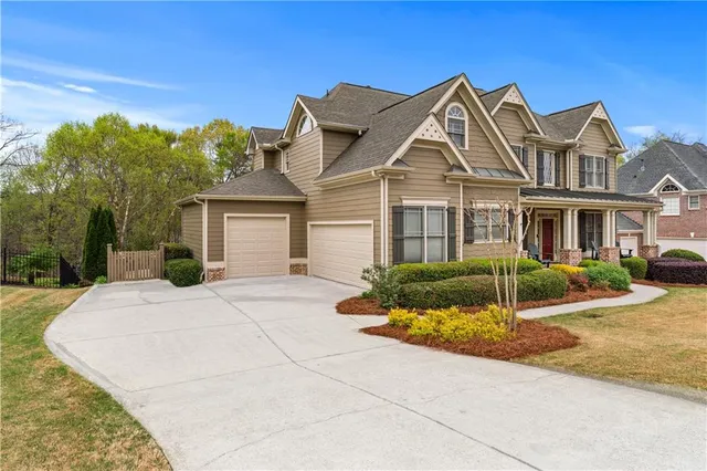 a front view of a house with a garden