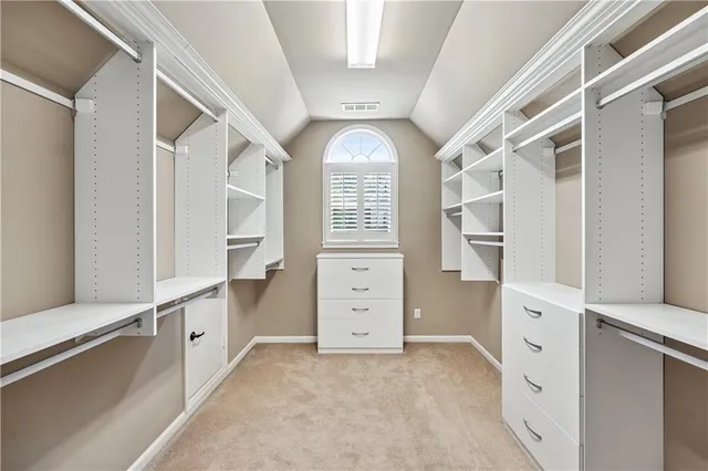 a view of a big room with wooden floor and windows