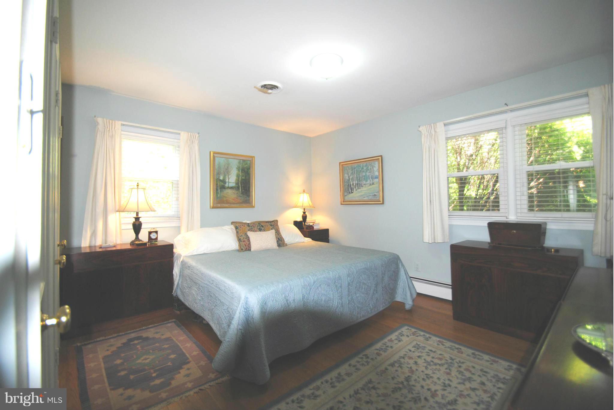 7921 Bainbridge Road Alexandria, VA 22308 - Photo 12 of 30 a bedroom with a large bed and a couch