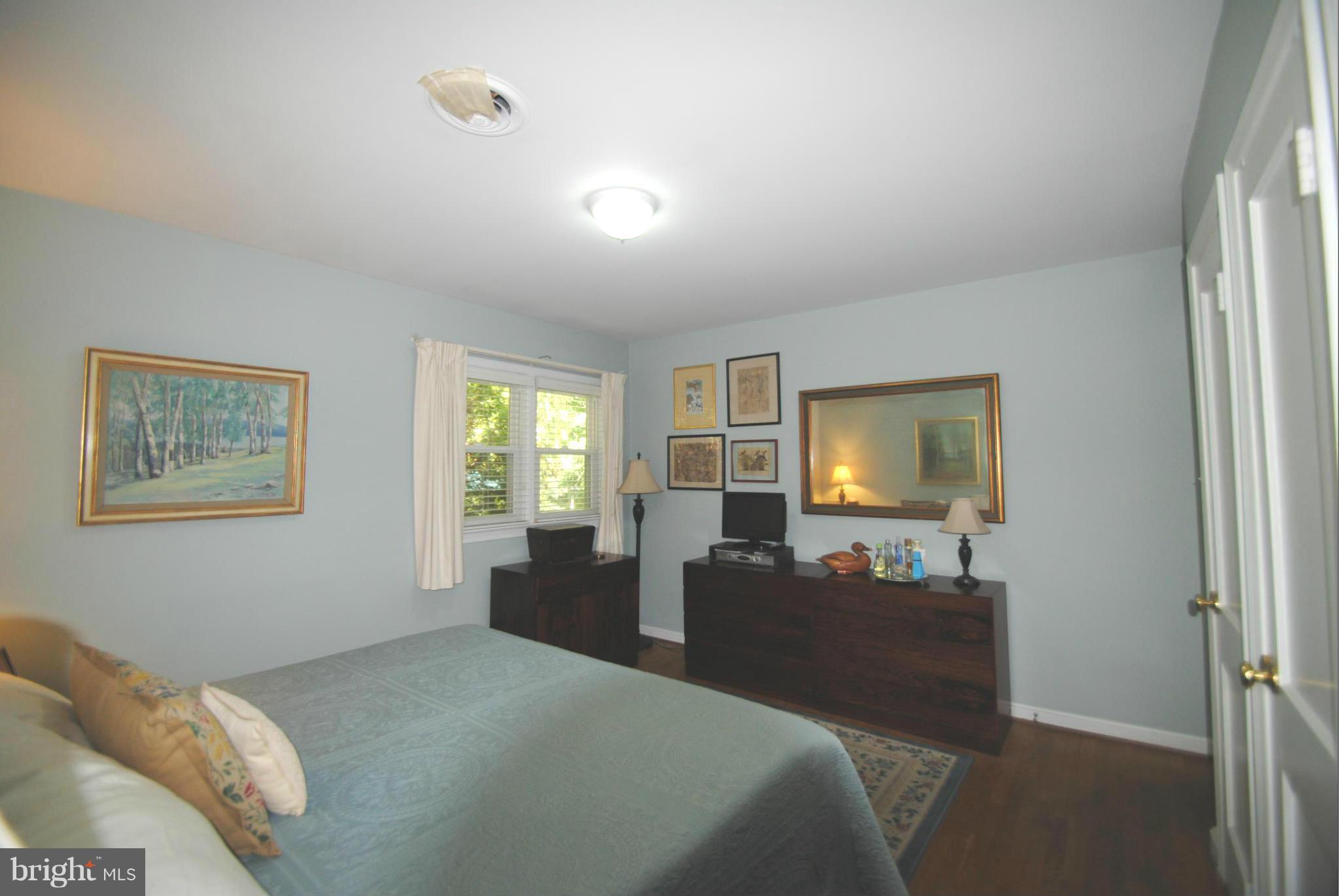 7921 Bainbridge Road Alexandria, VA 22308 - Photo 13 of 30 a bed room with a bed and a window