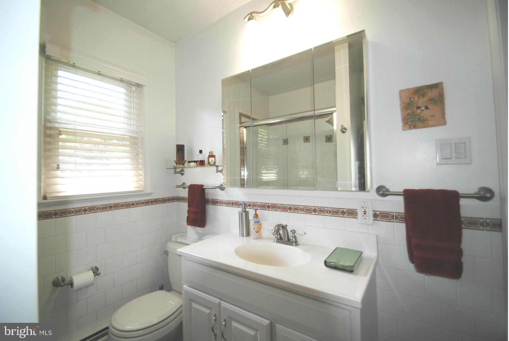 7921 Bainbridge Road Alexandria, VA 22308 - Photo 16 of 30 a bathroom with a sink and a mirror
