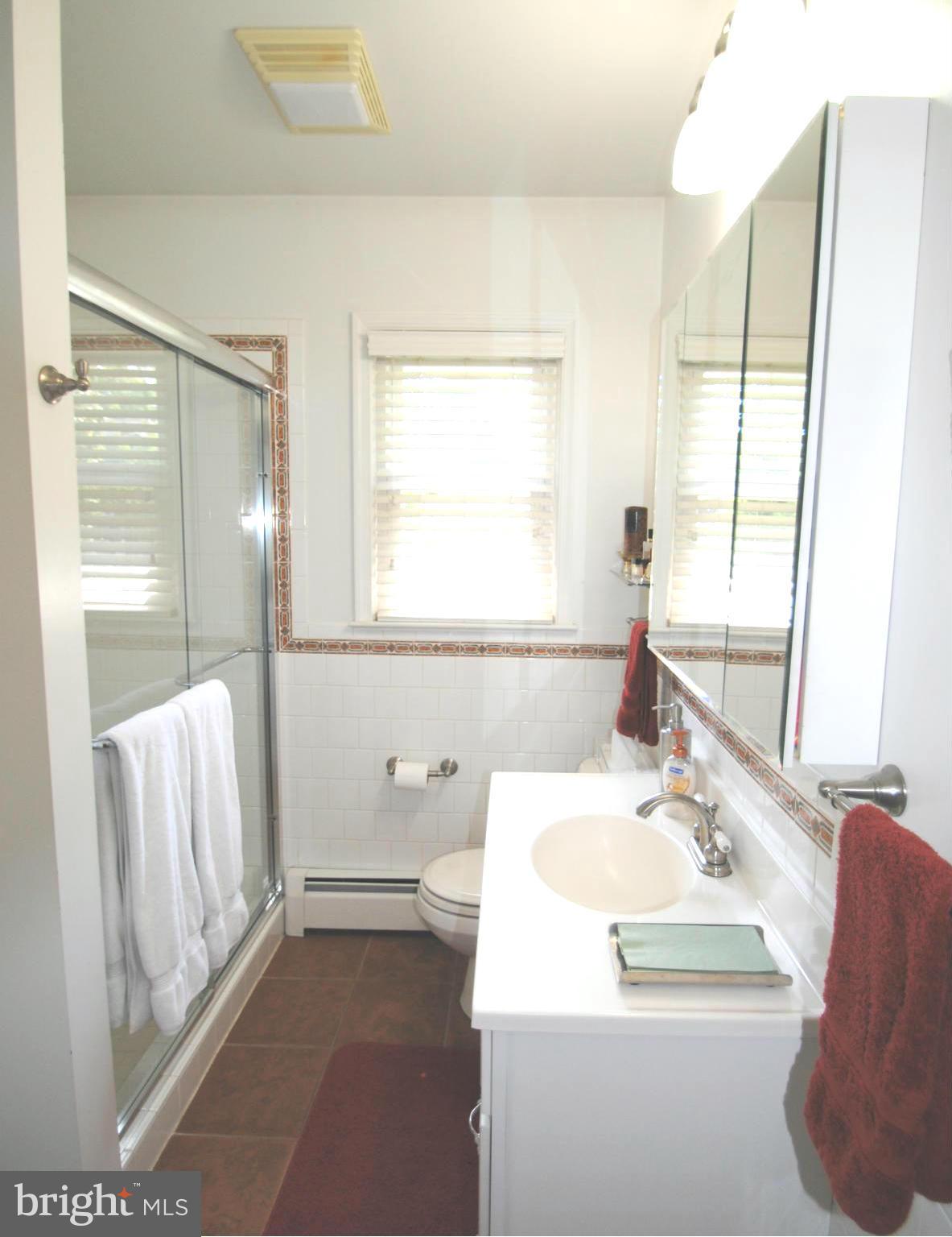 7921 Bainbridge Road Alexandria, VA 22308 - Photo 17 of 30 a bathroom with a sink a toilet and tub