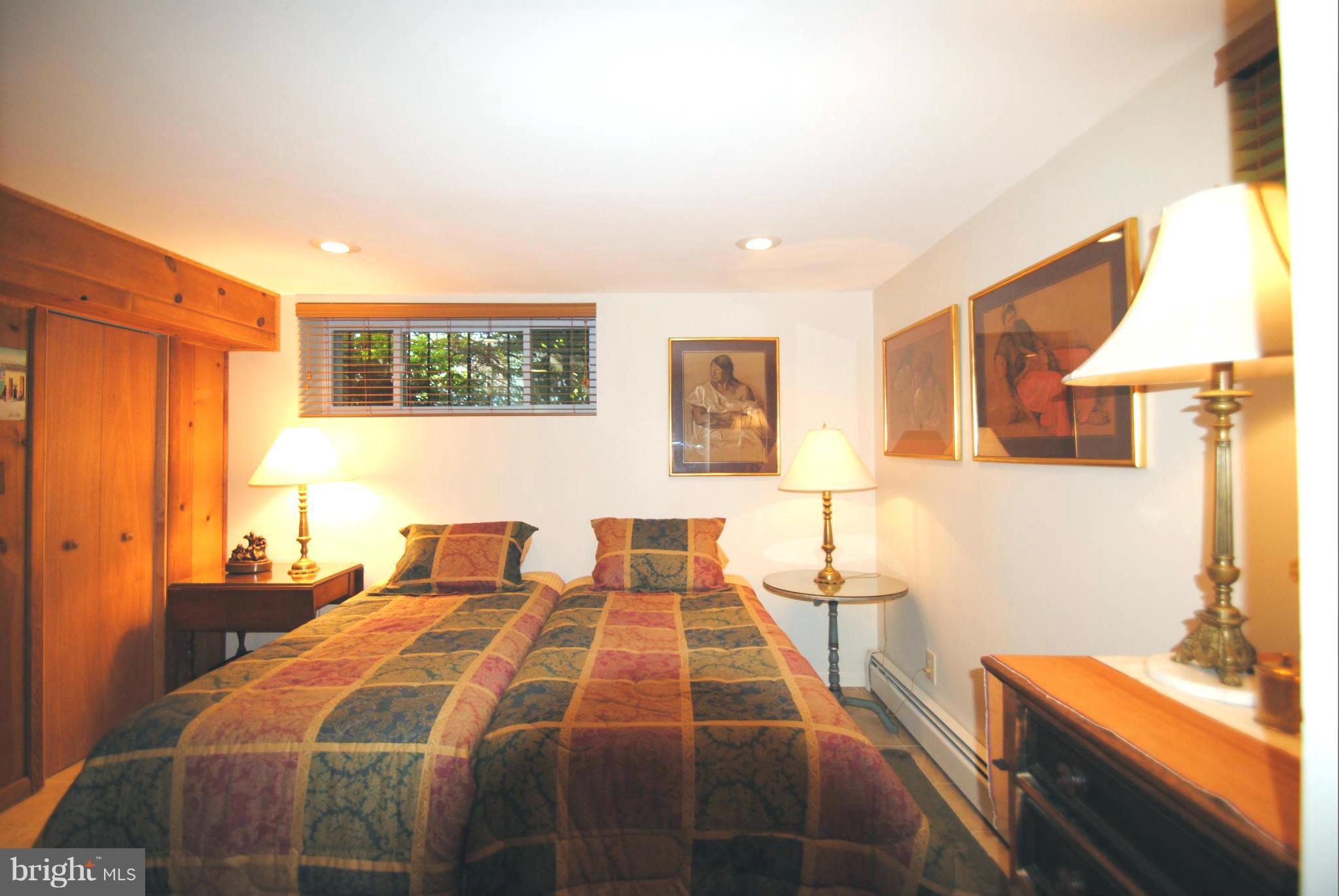 7921 Bainbridge Road Alexandria, VA 22308 - Photo 19 of 30 a bedroom with a bed and wooden floor