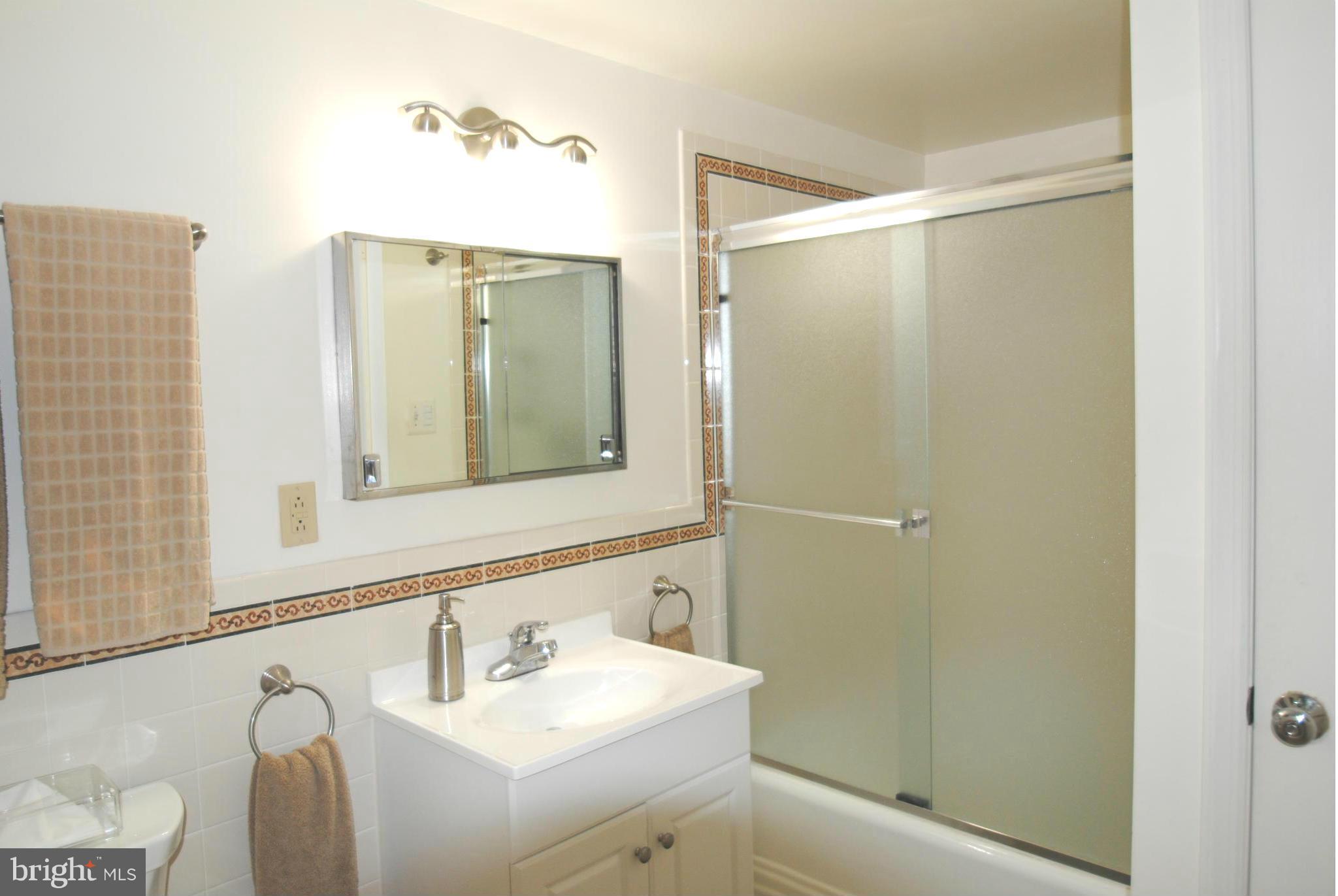 7921 Bainbridge Road Alexandria, VA 22308 - Photo 22 of 30 a bathroom with a sink and a mirror